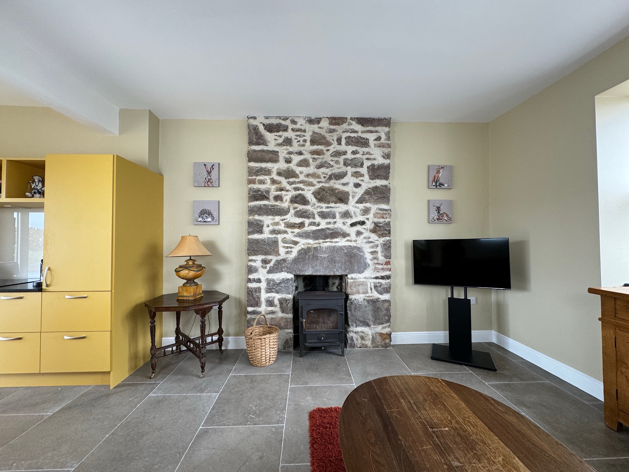 Open-plan kitchen and living room with stone fireplace