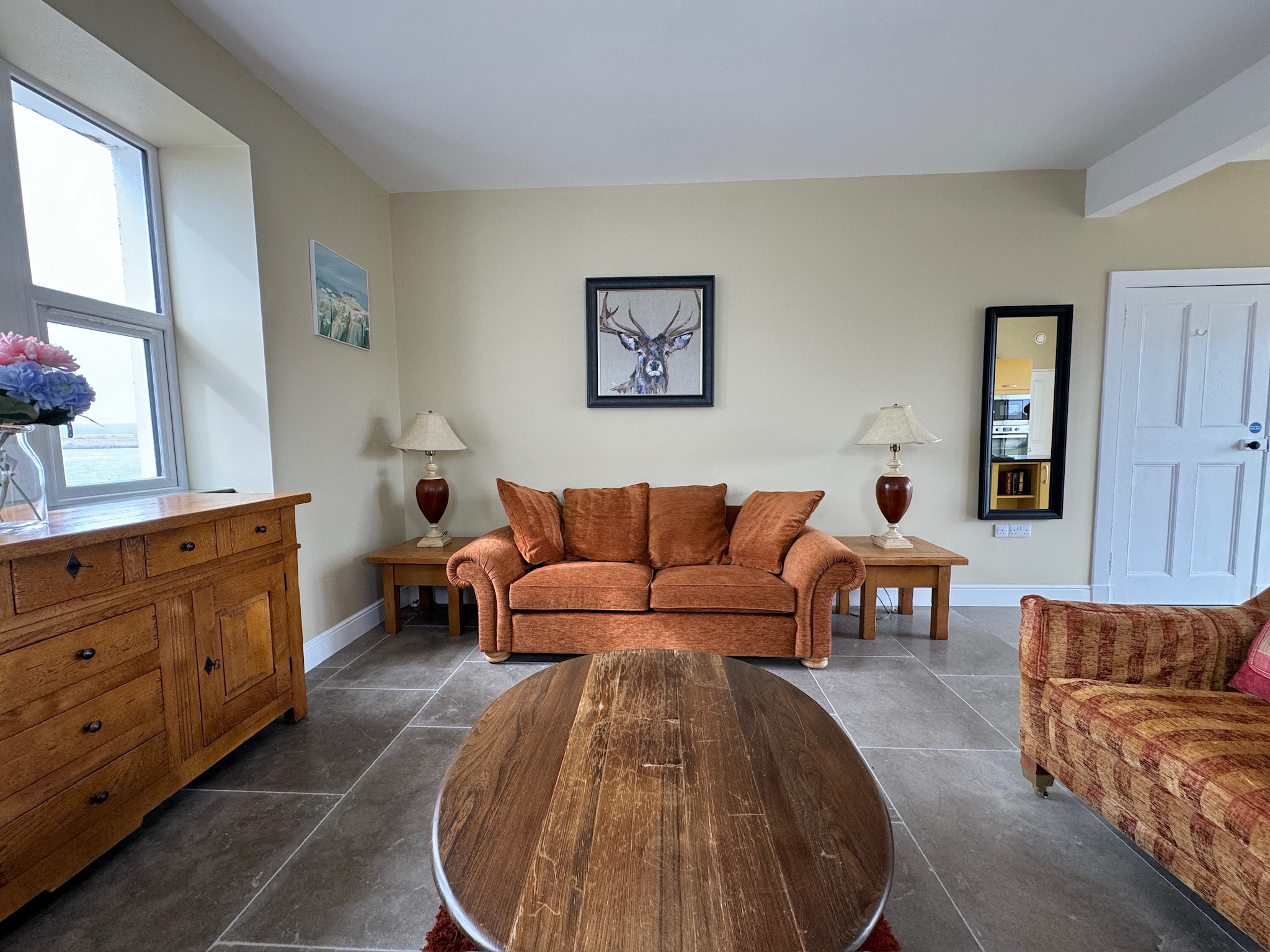 Living room with stag portrait and mirror