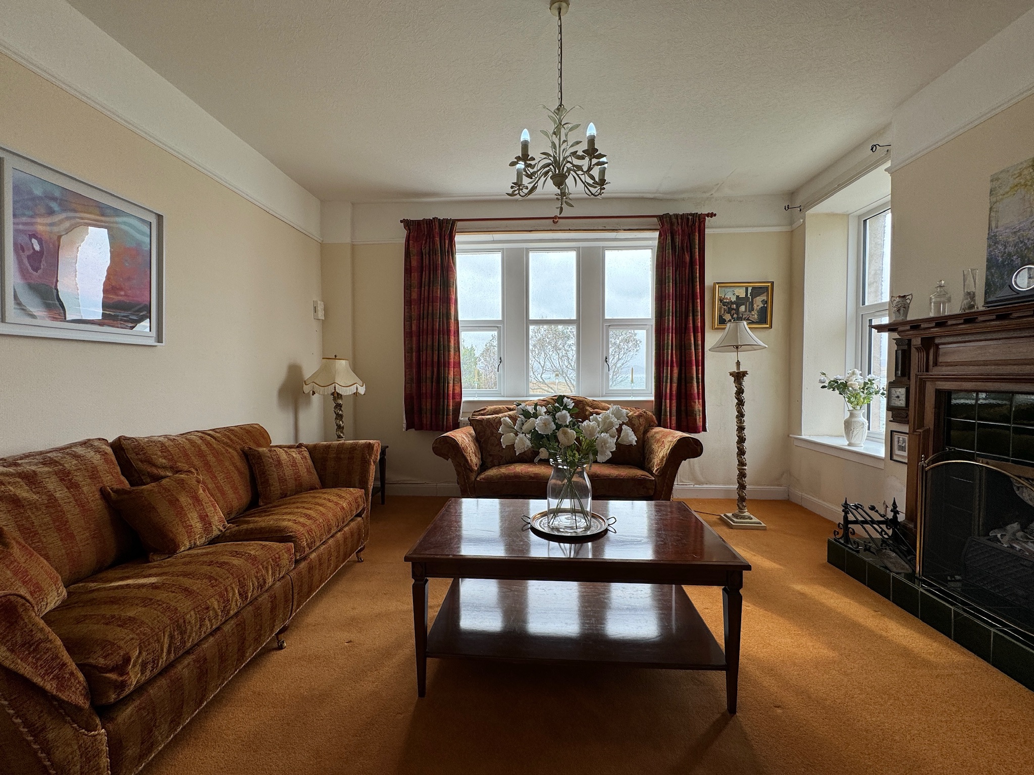 Living room with green-tiled fireplace, another view