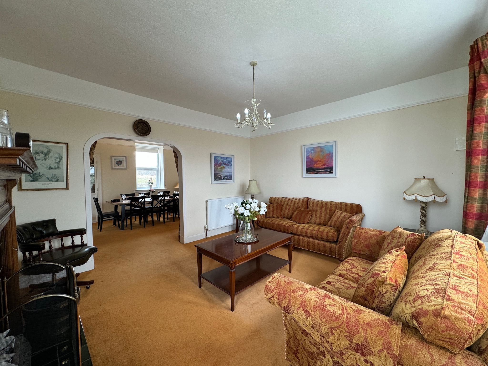 Living room with archway to the dining room