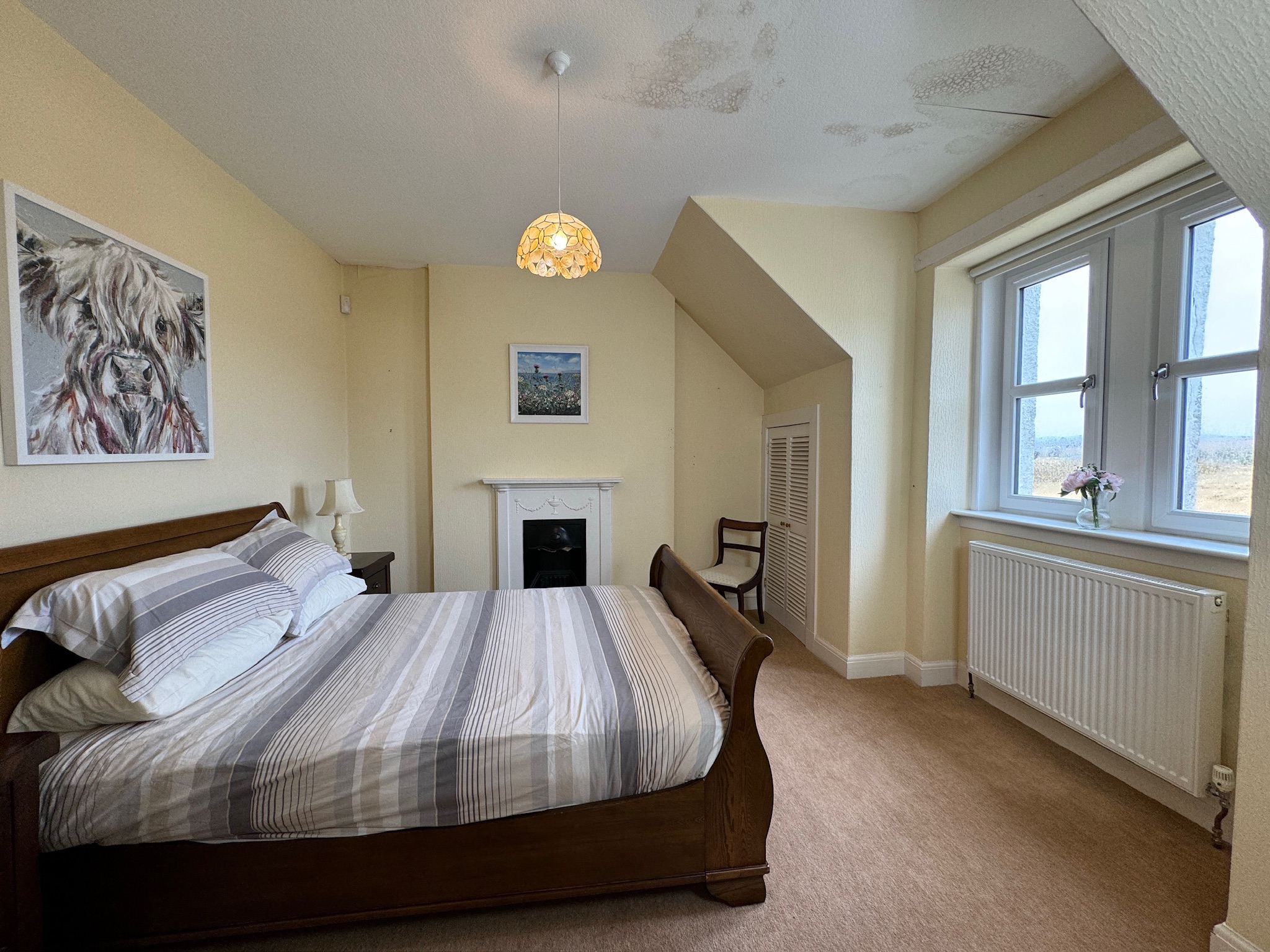 Bedroom with oak bed and fireplace, another view