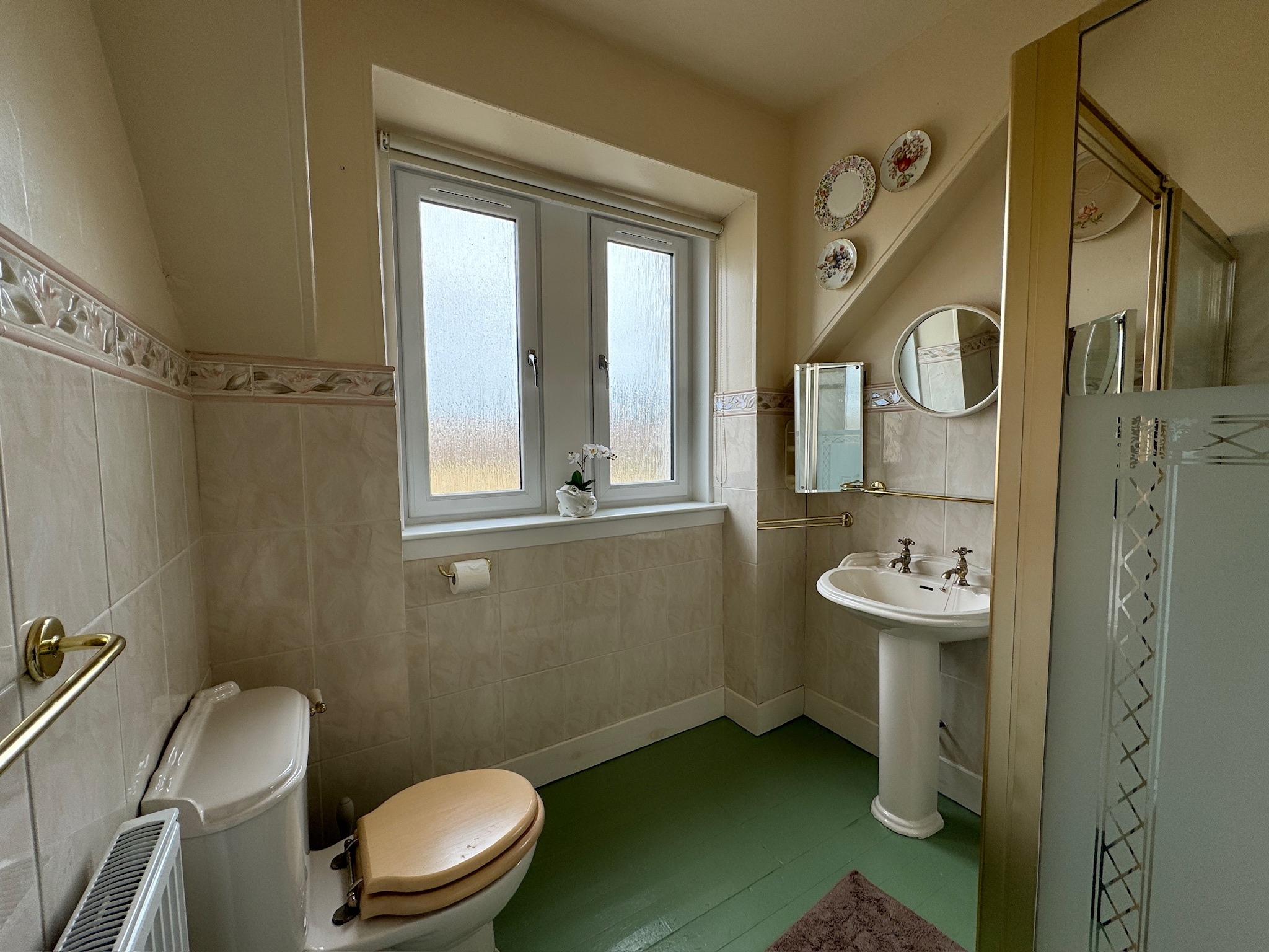 Bathroom with green flooring and vintage touches