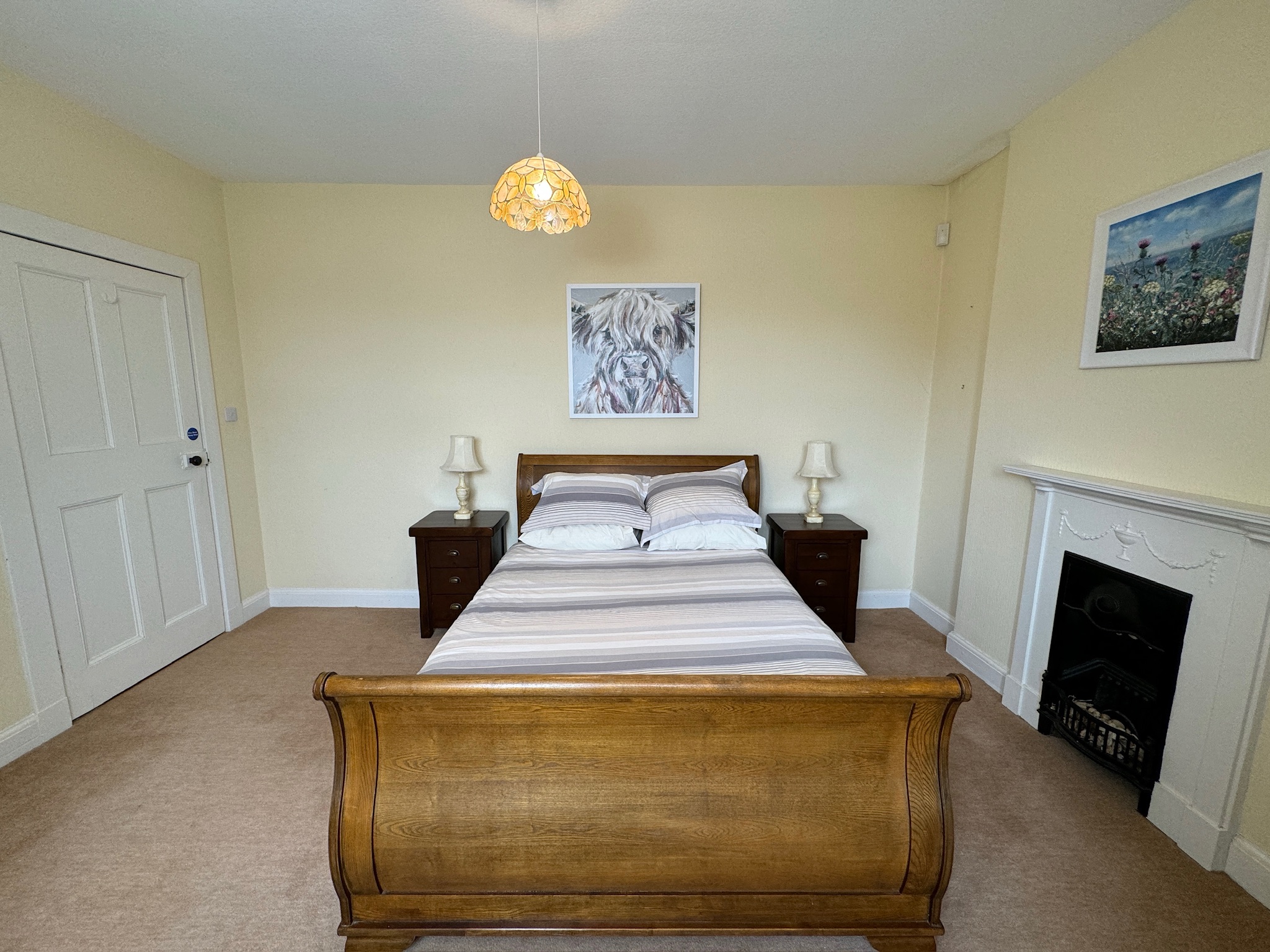 Bedroom with oak bed and fireplace