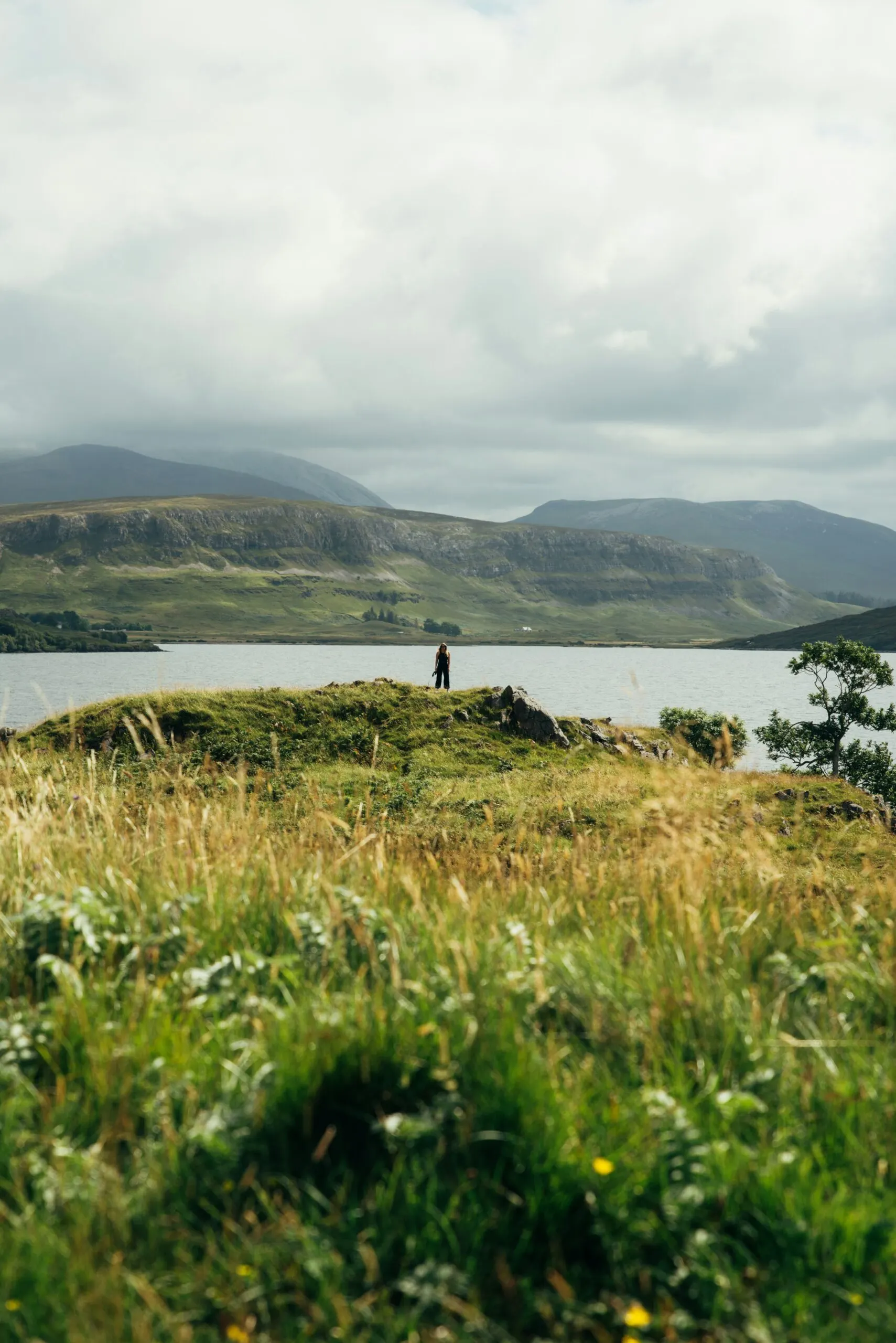 A walker admiring the view over a Highland loch along the NC500